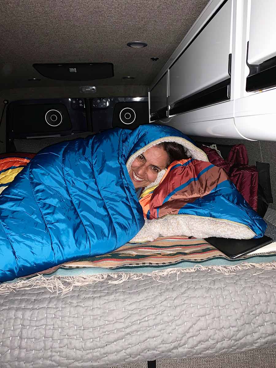 TouRig-custom-bed-and-comfy-mattress-2 Suzy enjoys the custom mattress and bed in their custom Sprinter van