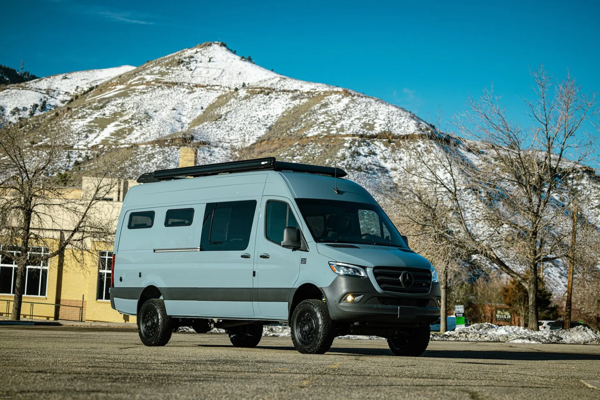 TOURIG Sprinter 170 Banner custom grey blue van build in front of a mountain range in Colorado